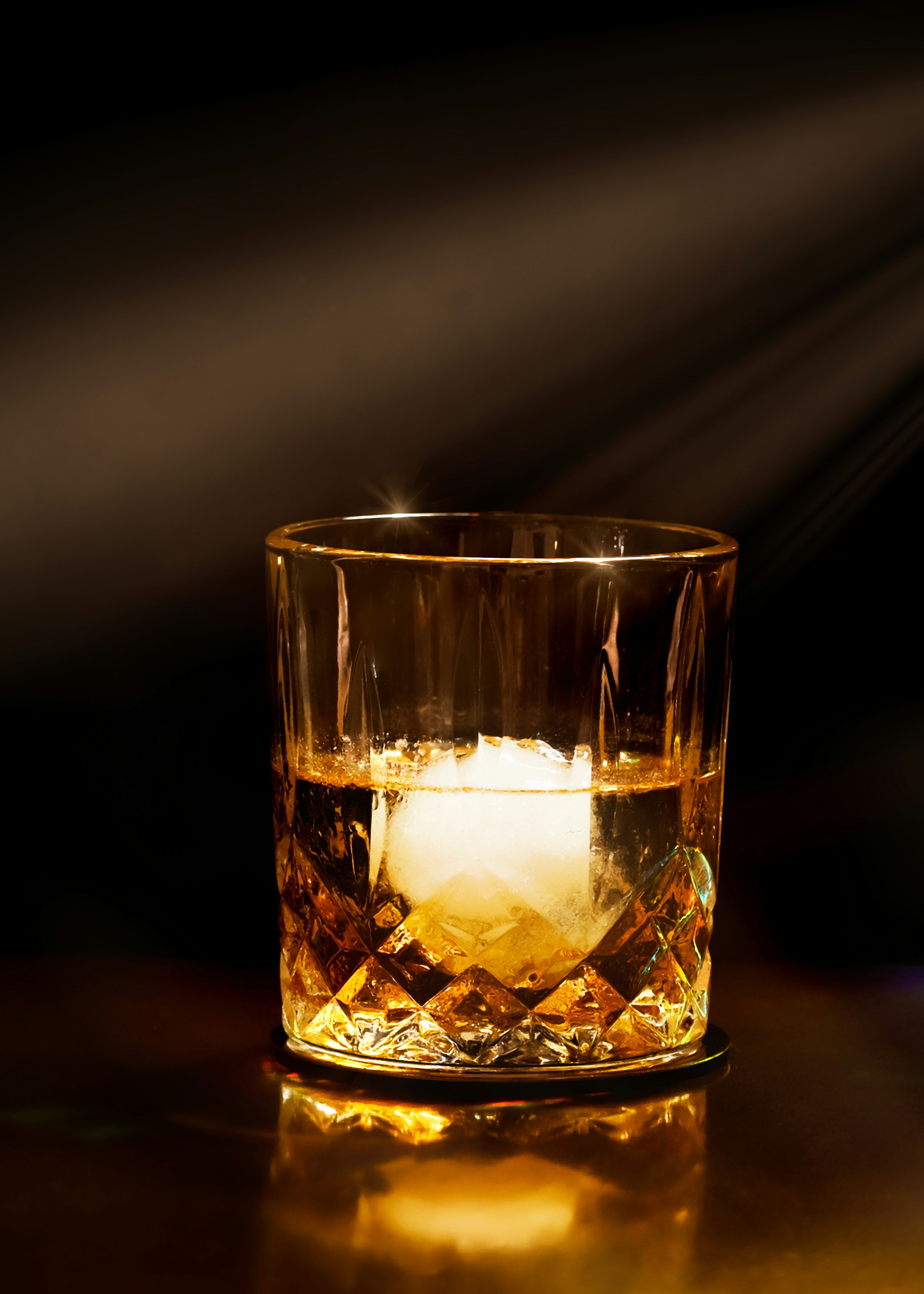 Whisky in a rocks glass with a sphere ice cube